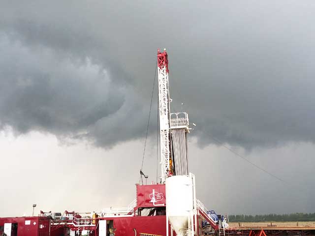 Tempco Rig #6 with 72' mast against a grey central Alberta sky Tempco Leduc Rig #6